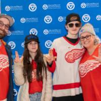 Susan Proctor standing with her family at the Red Wings game.